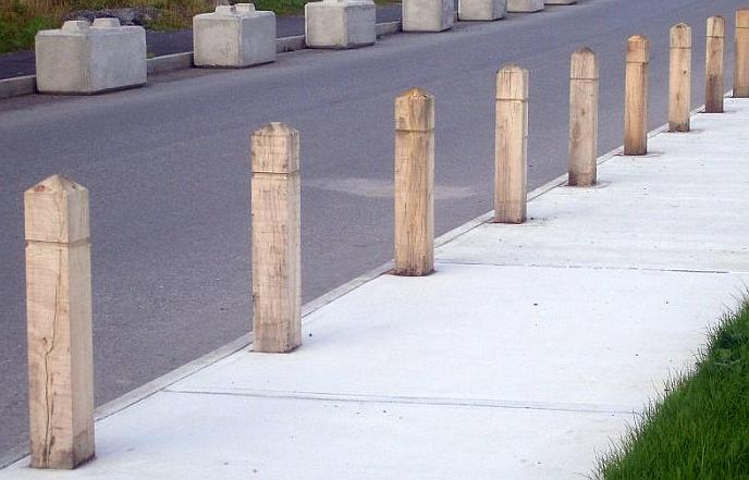 group of pointed timber bollards